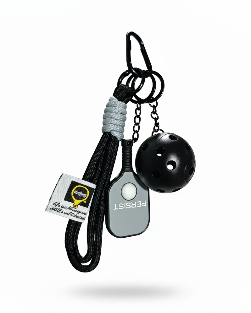 Clean product photo of black and grey pickleball keychain on white background