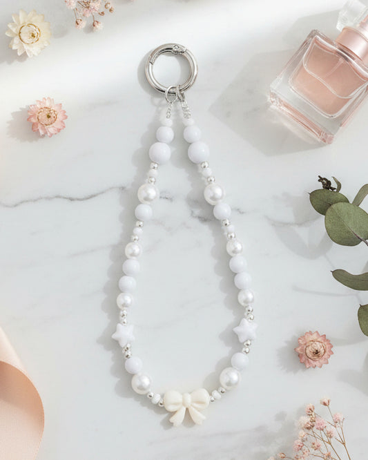 White pearl beaded phone charm wristlet with bow charm