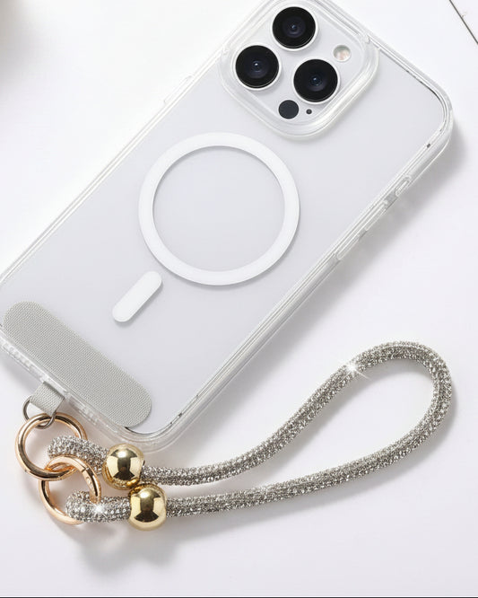 A clear mobile phone case with a luxury rhinestone lanyard attached to it, featuring a sparkling strap and rhinestone clasps.