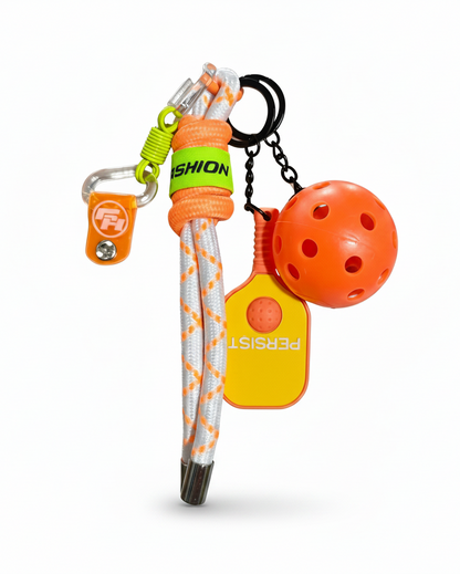 Clean product photo of orange pickleball keychain on white background