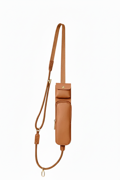 Caramel tan multifunction crossbody phone pouch with adjustable shoulder strap, top flap pocket, front zippered compartment, and gold-tone hardware on white background