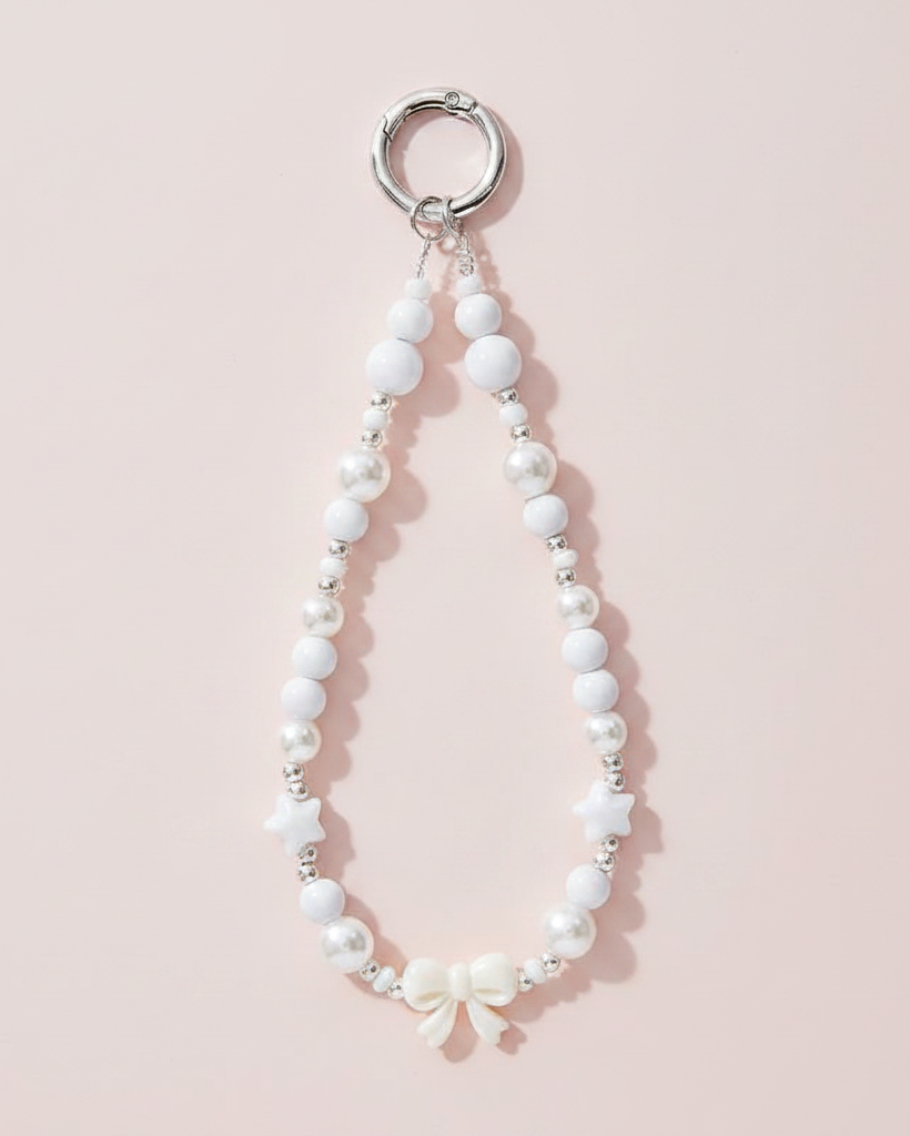 White Beaded Phone Charm Wristlet on Blush Background